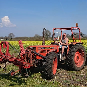 Organic farmer hoeing with tractor at farm Velhorst in the East of the Netherlands